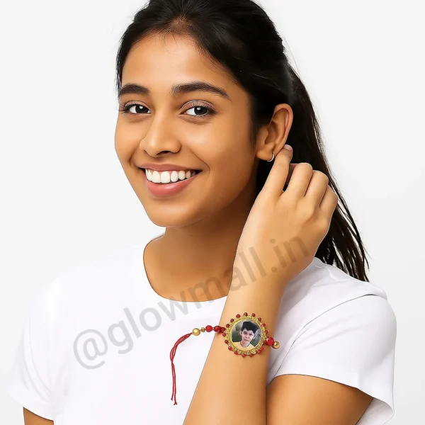 A girl wearing an ornate, jewelled photo Rakhi from Glow Mall on her wrist, personalized with a brother's picture in the center.