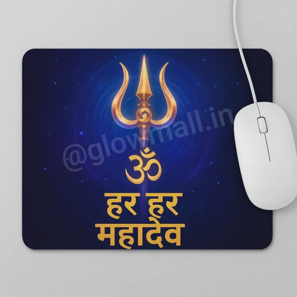 A dark blue Glow Mall mousepad featuring a golden Trishul, the Om symbol, and the Hindi mantra 'Har Har Mahadev', with a white mouse resting on it.