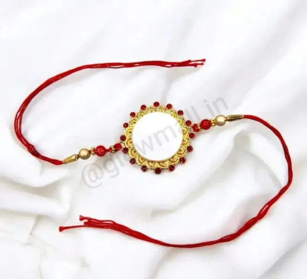 A blank personalized Rakhi from Glow Mall with an ornate red jewelled and golden frame, with a white center ready for photo customization.