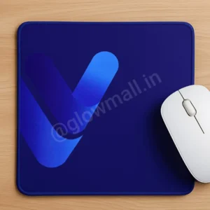 A dark blue Glow Mall mousepad on a wooden desk, featuring a modern, gradient blue abstract 'V' logo, with a white mouse on the right.