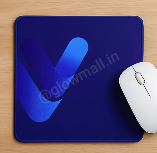 A dark blue Glow Mall mousepad on a wooden desk, featuring a modern, gradient blue abstract 'V' logo, with a white mouse on the right.