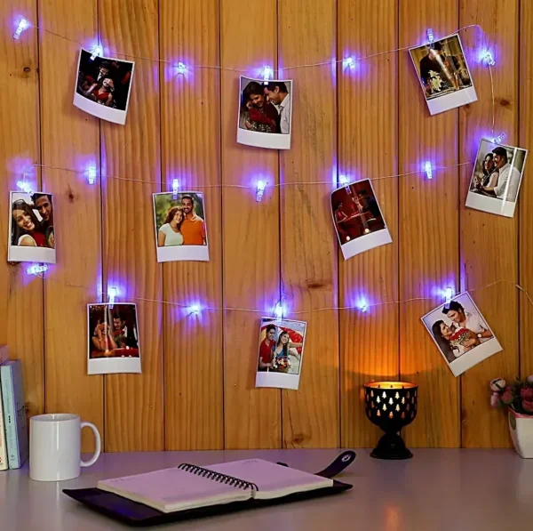 A beautiful room decoration idea using Glow Mall's custom Polaroid photo prints clipped onto a string of warm fairy lights on a wall.